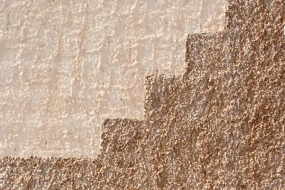 Close-up of light and dark textured wall coatings, image for Los Angeles Stucco Build & Repair.